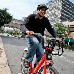 Photo: Man riding Capital Bikeshare bike